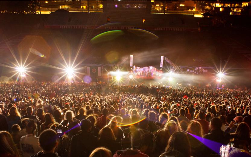 A crowd watches a laser light show at Cornell.
