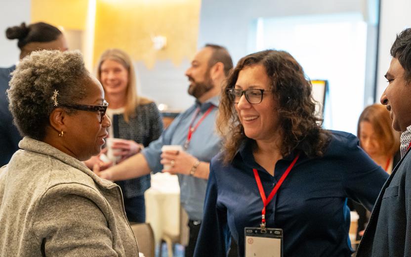 a group of colleagues chat during a workshop break
