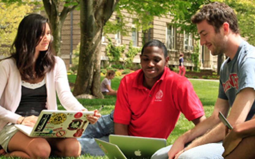 Students study together outside on a pleasant summer day