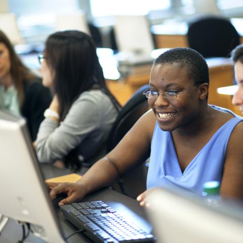 Staff collaborating at a computer