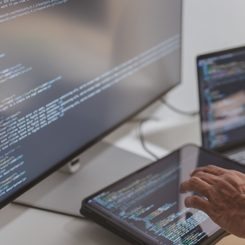 Person creating code on various computers
