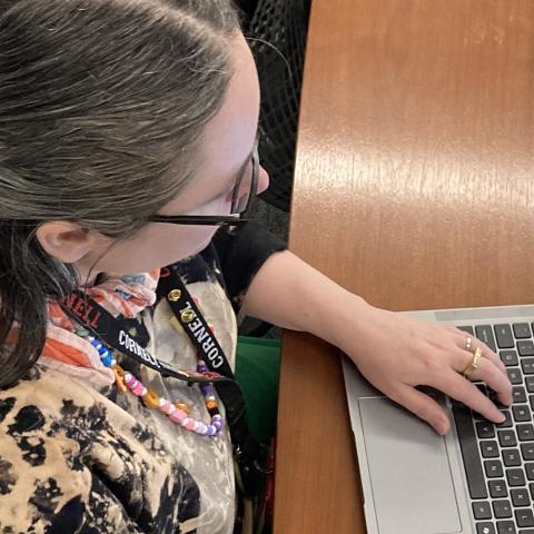 an employee types on a laptop