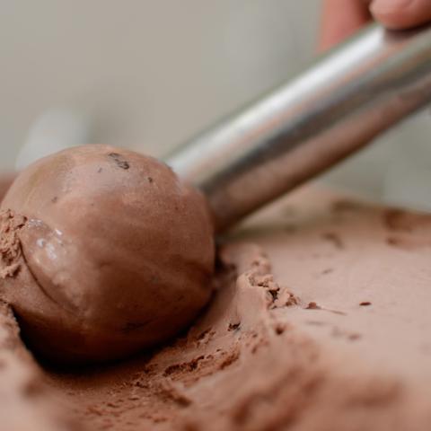 Chocolate ice cream being scooped.